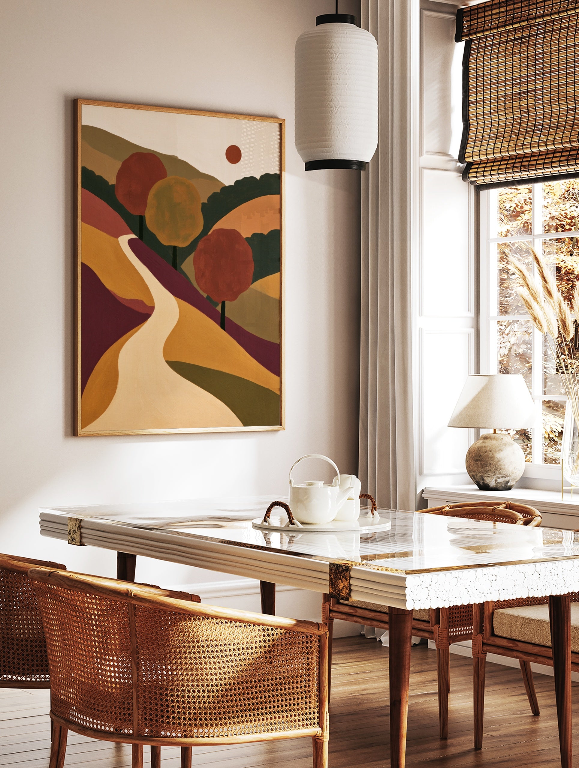 Abstract landscape wall art featuring a winding path through rolling hills, red and yellow trees, in a styled room mockup