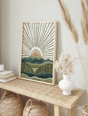 Abstract mountain landscape art print with layered green and blue peaks and a peach sun with, in an alternate framed mockup