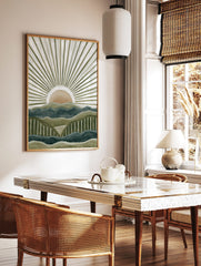 Abstract mountain landscape art print with layered green and blue peaks and a peach sun with white, in a styled room mockup