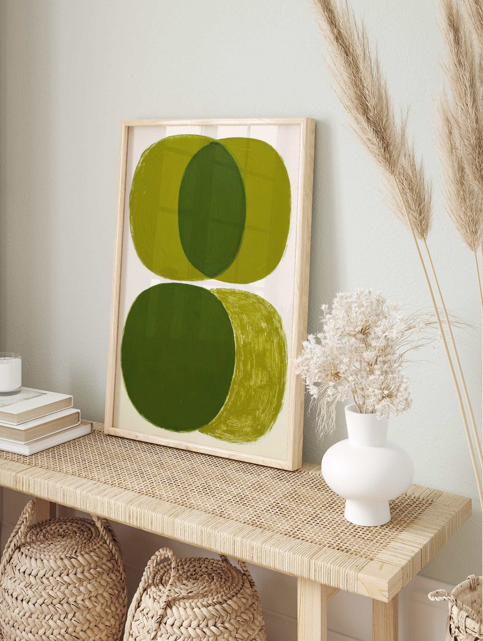 Abstract art print with overlapping olive green ovals and visible brushstrokes on white, in an alternate framed mockup