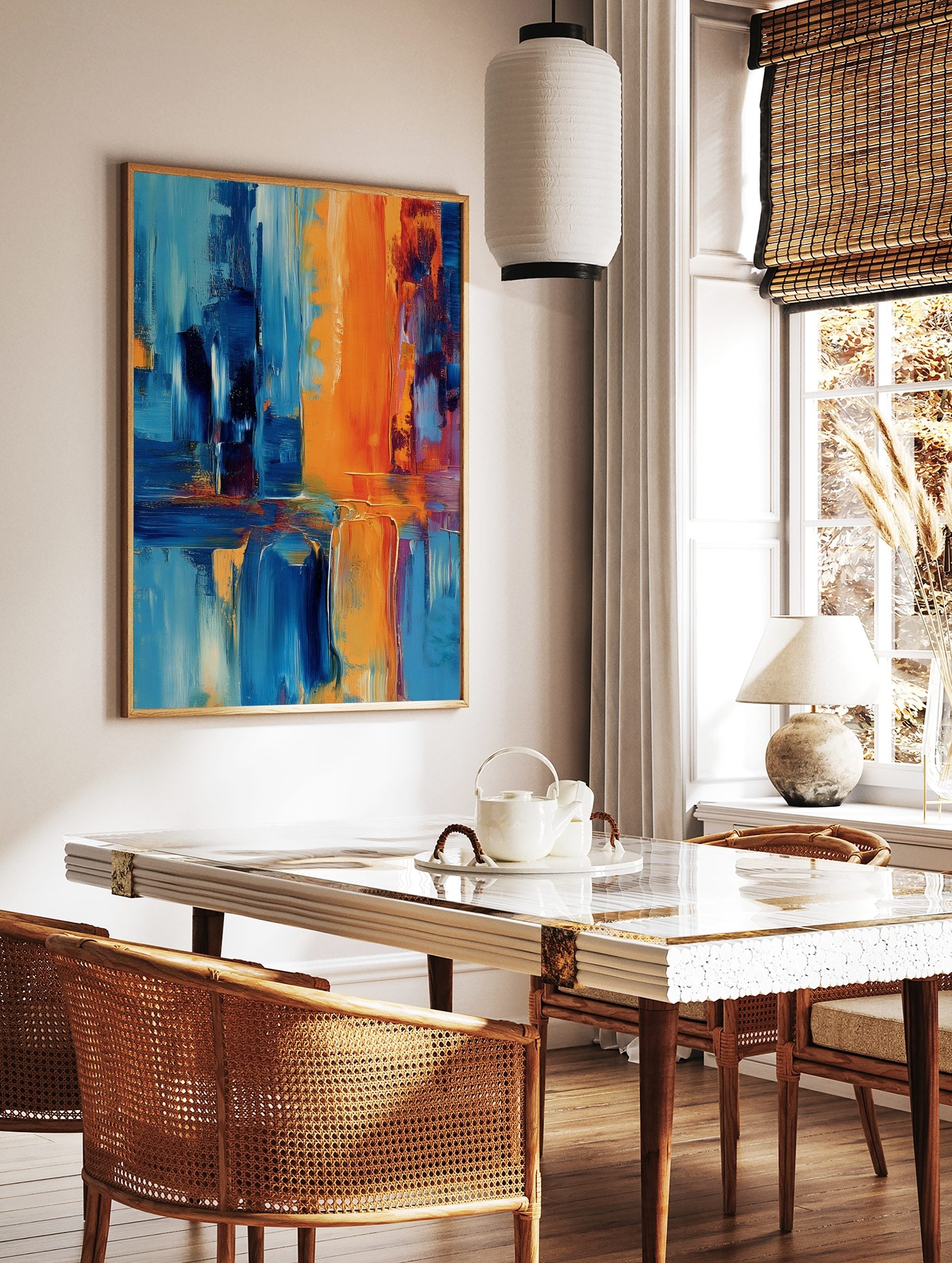Abstract art print with bold vertical and horizontal strokes in orange and shades of blue, showing, in a styled room mockup