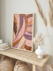 Abstract art print with flowing, curved bands of brown, pink, and lavender, featuring dotted, in an alternate framed mockup