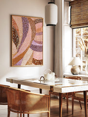 Abstract art print with flowing, curved bands of brown, pink, and lavender, featuring dotted and, in a styled room mockup