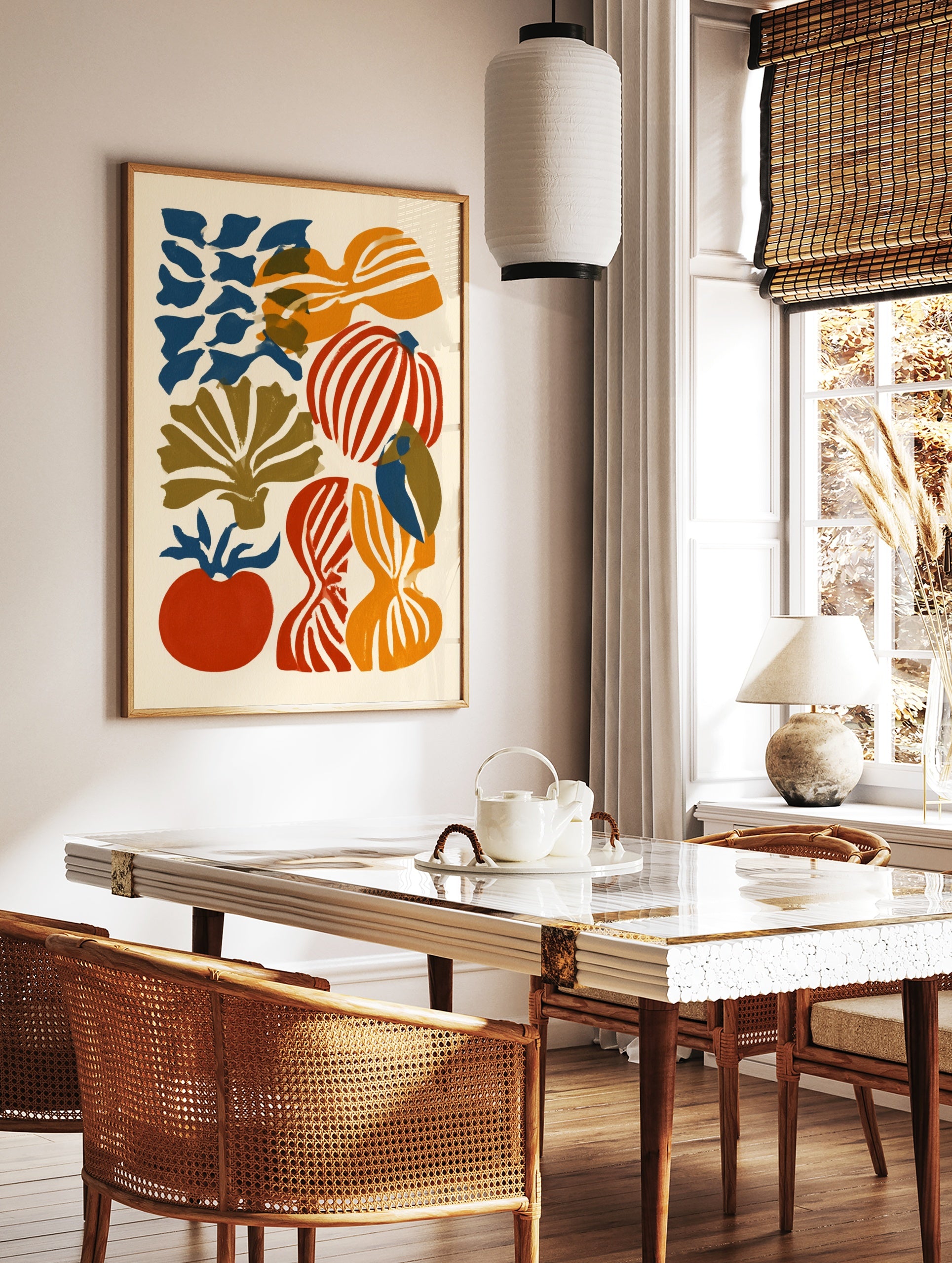 Abstract illustrative wall art with organic red, orange, and blue vegetable shapes on a cream, in a styled room mockup