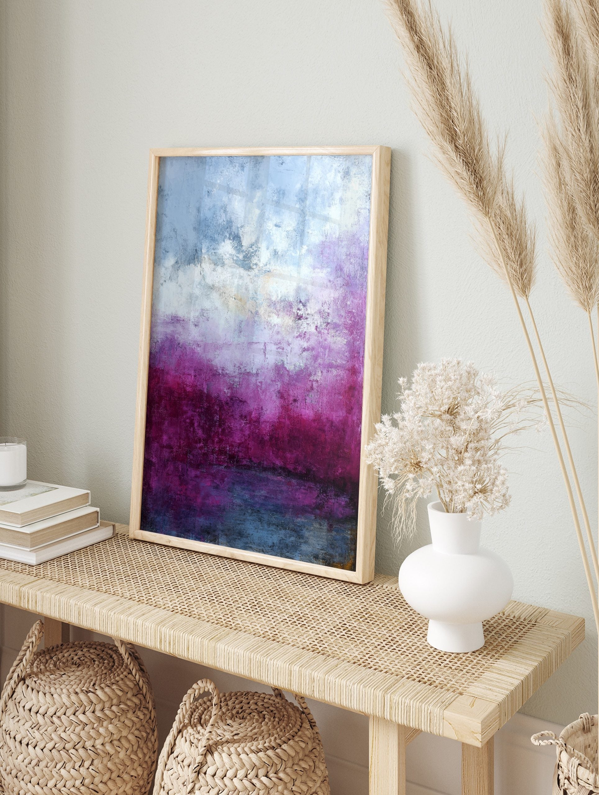 Abstract painting with textured layers of deep magenta, purple, white, and blue, creating an, in an alternate framed mockup