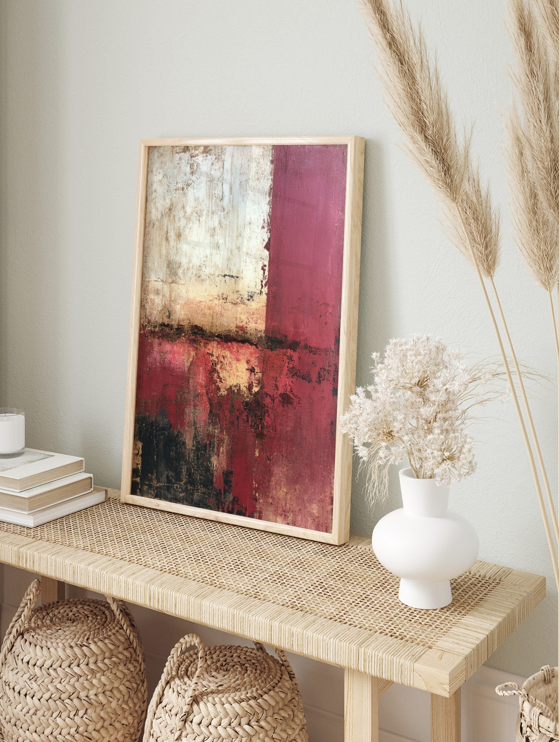 Abstract wall art with distressed red, white, and black textures, and gold highlights in a, in an alternate framed mockup