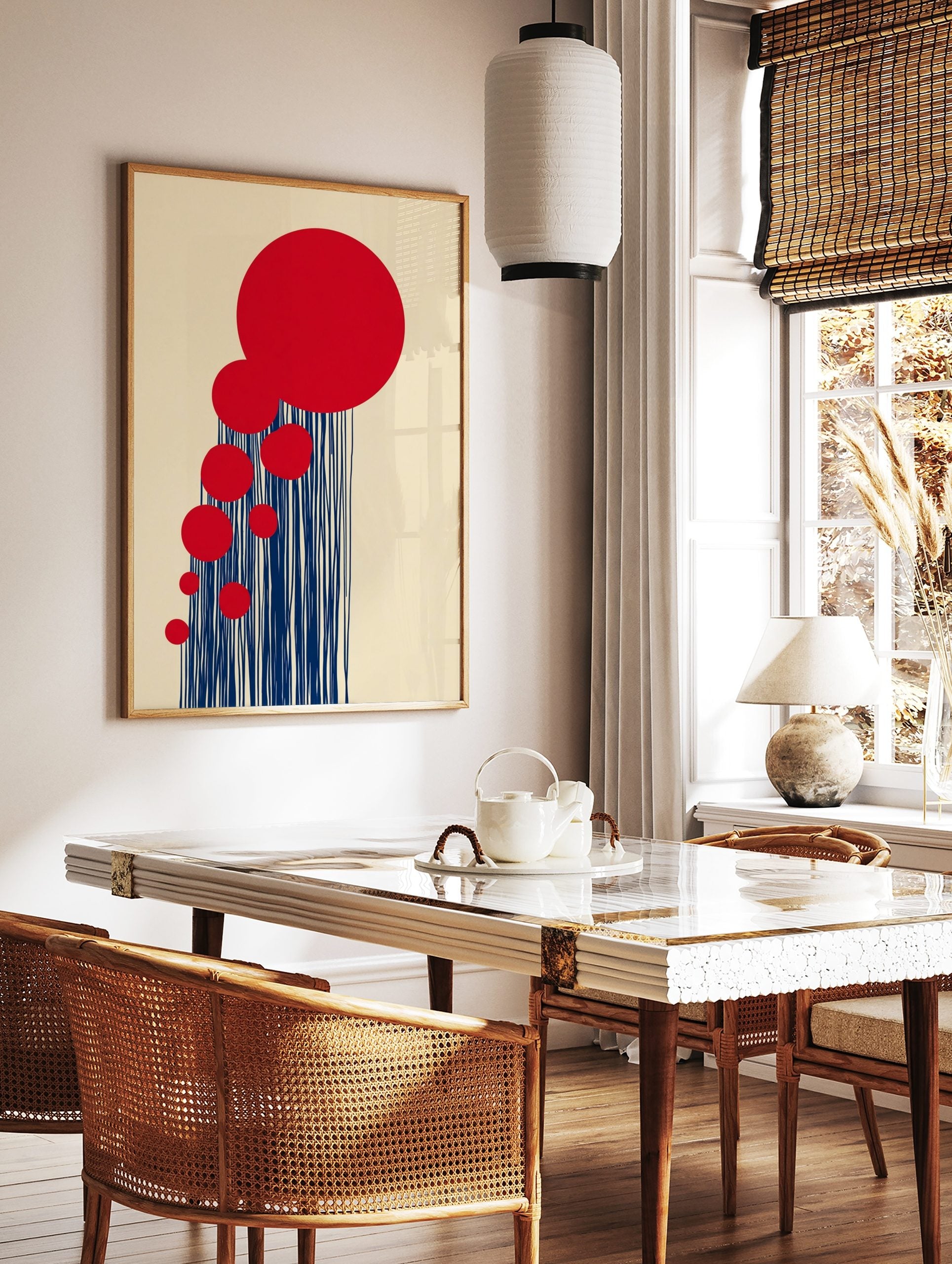 Abstract art print with cascading red circles and vertical navy blue lines on a beige background, in a styled room mockup