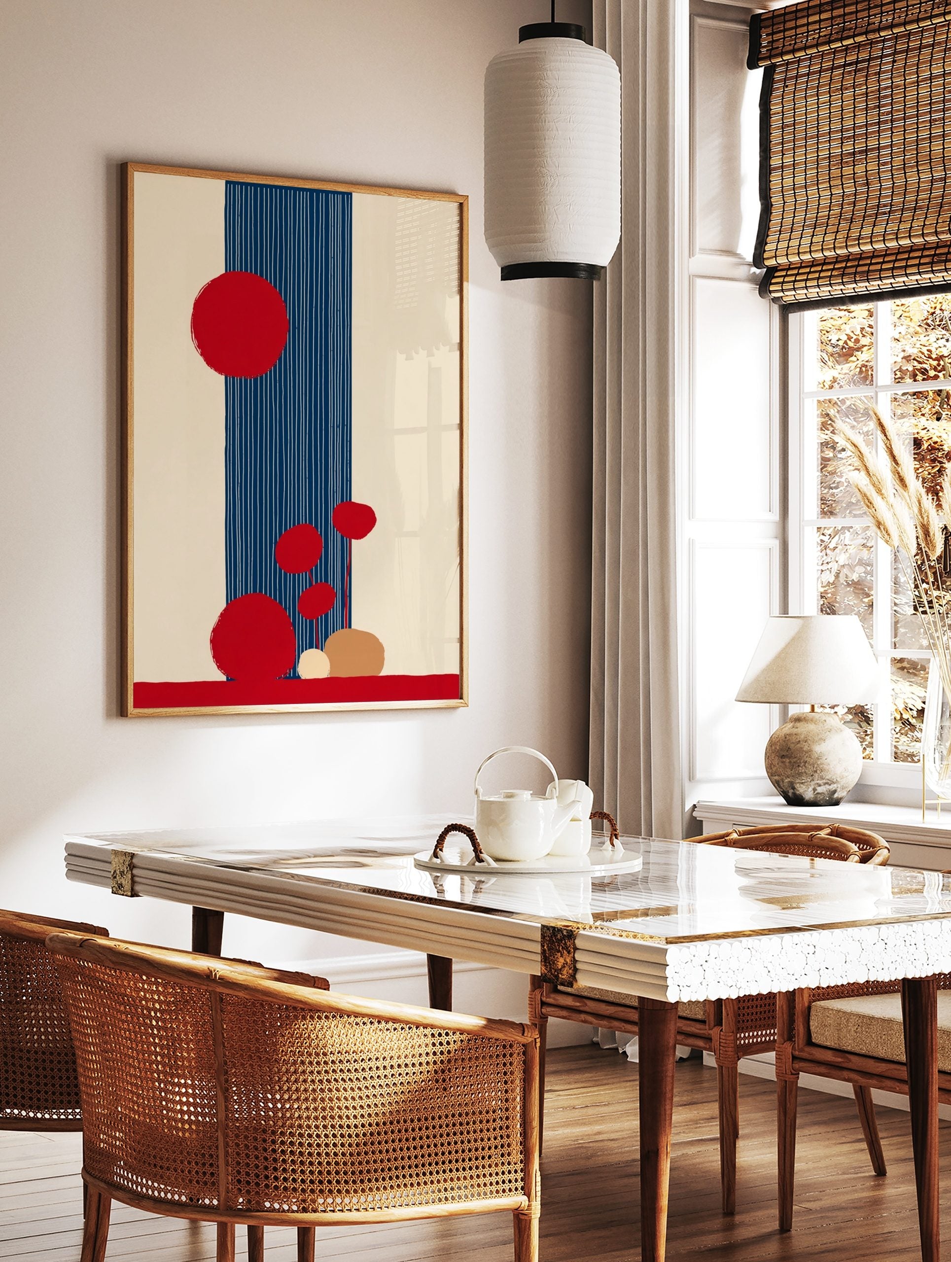 Abstract art print with large and small red circles, a navy blue vertical stripe with white lines, in a styled room mockup
