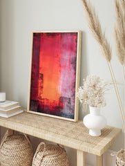 Abstract wall art with vertical red, orange, and pink colour blocks and distressed dark, in an alternate framed mockup