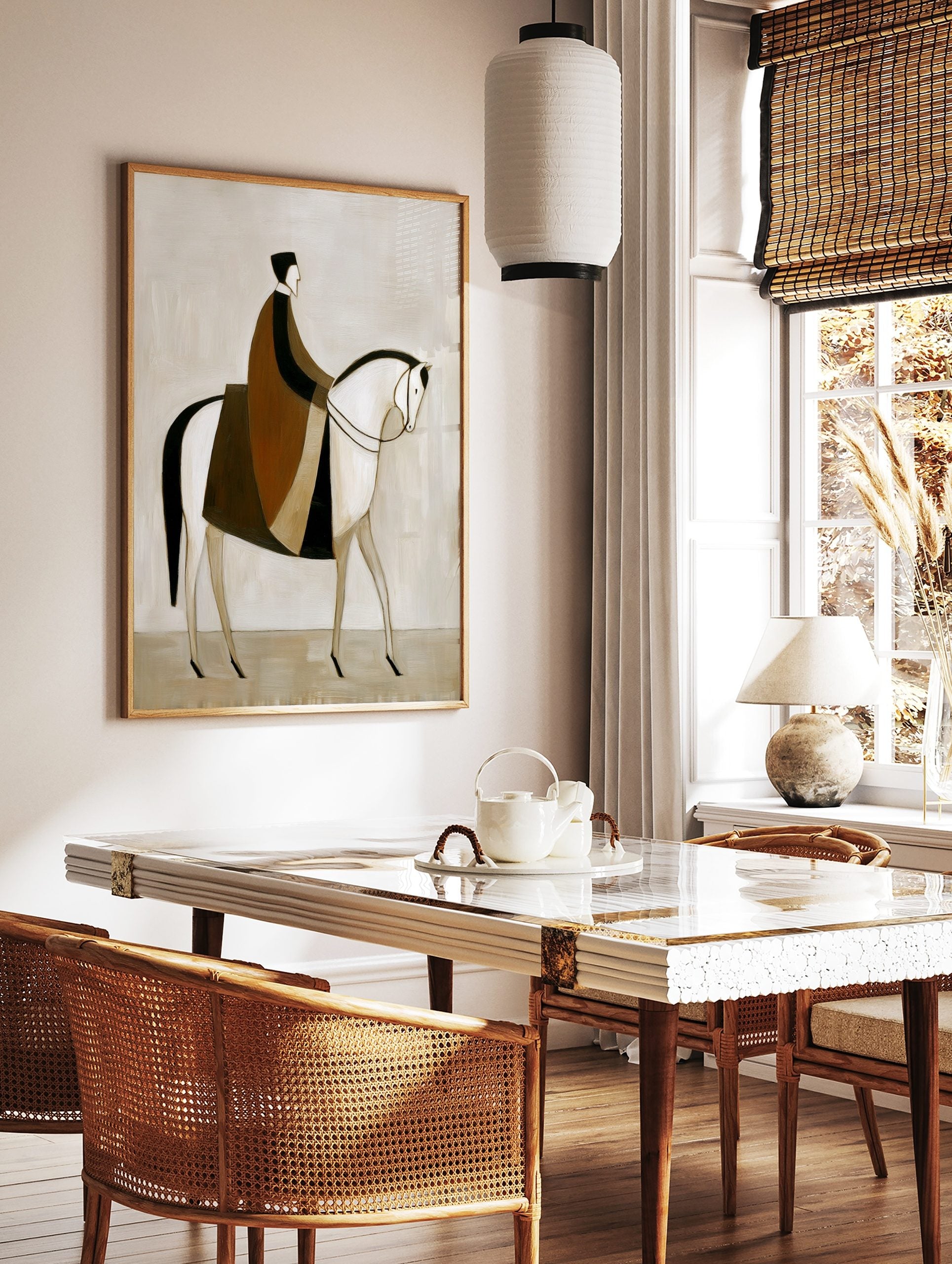 Stylised abstract painting of a rider in brown and black cloak on a white horse, facing right on a, in a styled room mockup