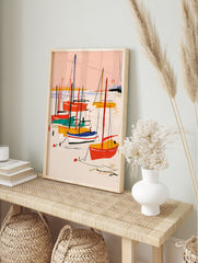 Abstract sailboat art print with red, yellow, and teal boats on a pink background, in an alternate framed mockup