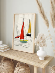 Abstract sailboat illustration with red, yellow, and navy sails and black hand-drawn lines on, in an alternate framed mockup