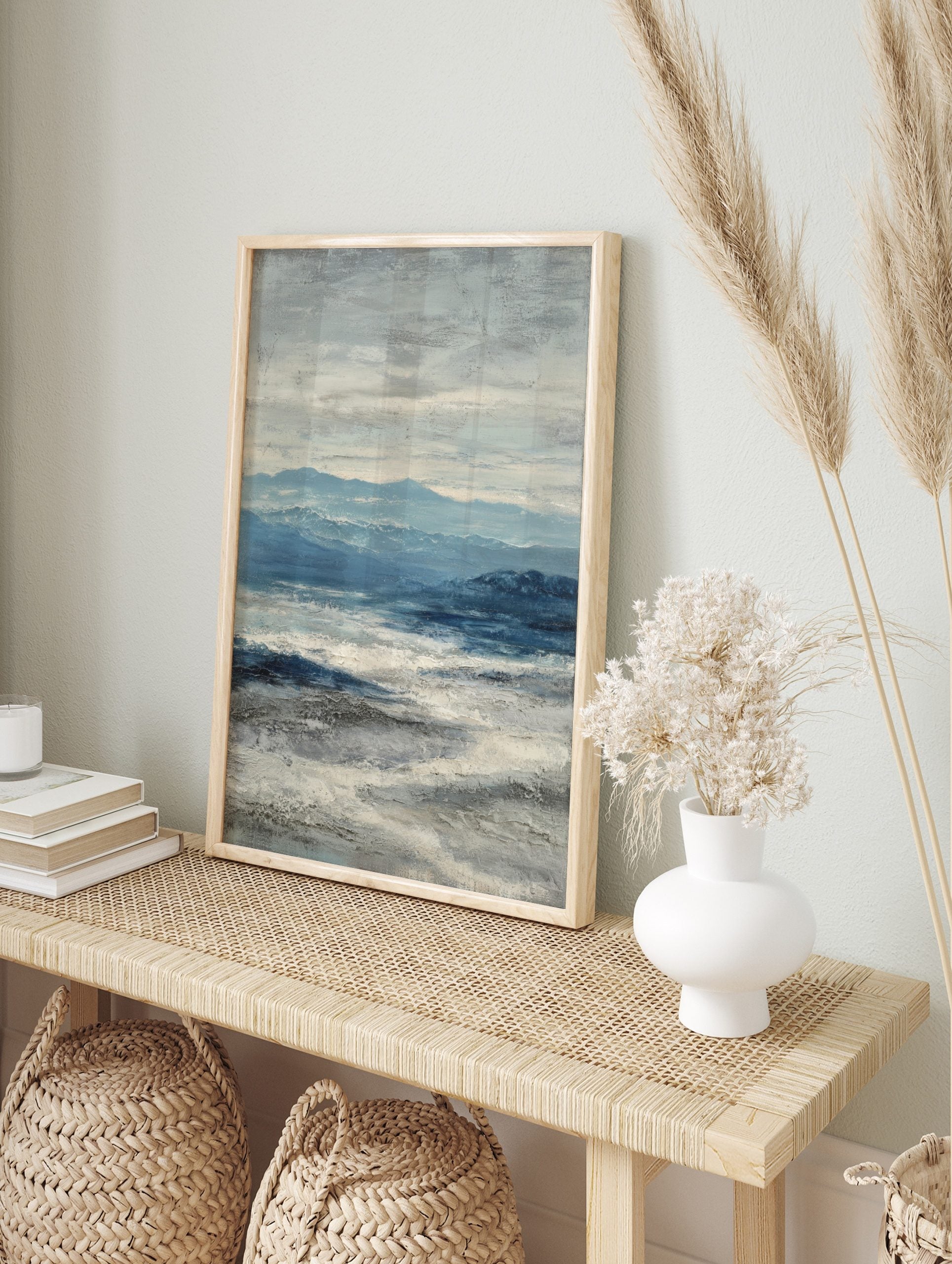 Abstract seascape painting with blue mountains, deep blue ocean, and textured white waves, in an alternate framed mockup