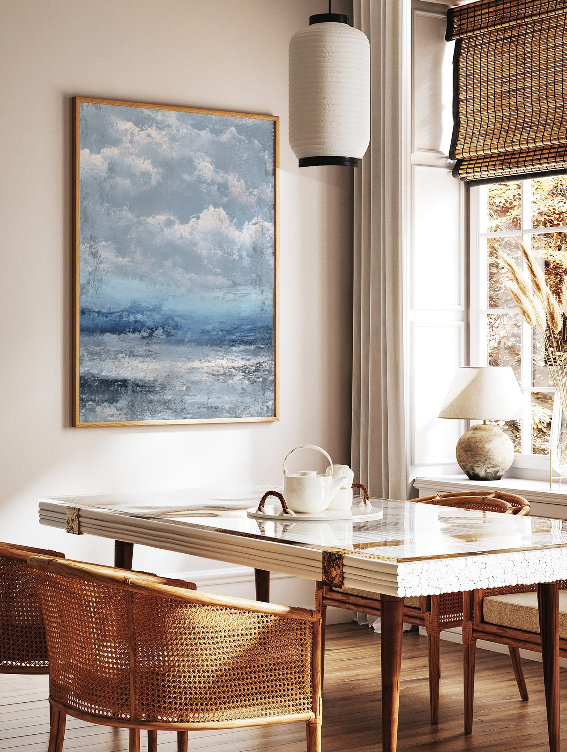 Textured abstract seascape art print with stormy blue and grey clouds over choppy ocean water, in a styled room mockup
