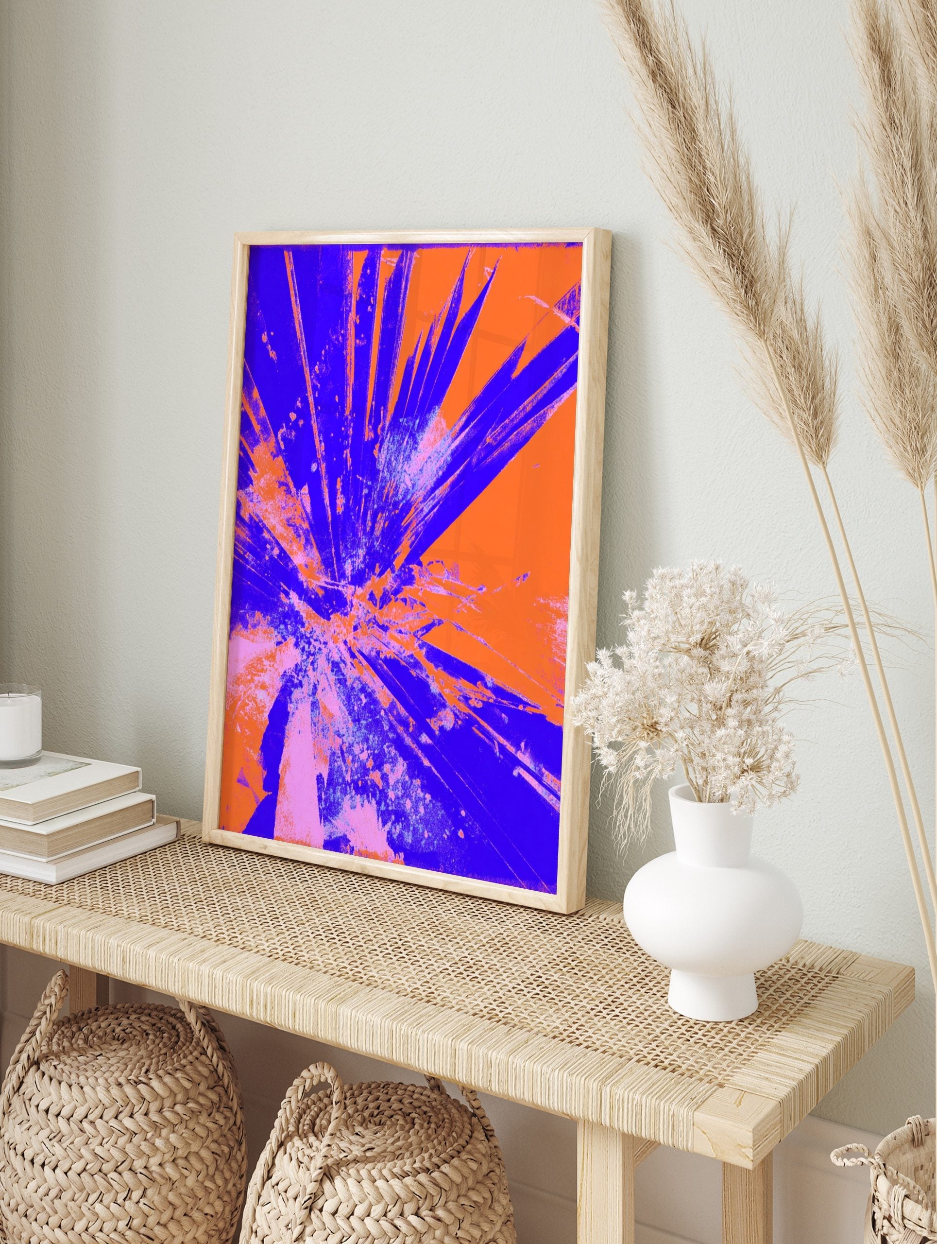 Abstract art print with radiating blue and orange shattered glass or explosive burst effect, in an alternate framed mockup