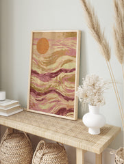 Abstract art print with an orange circle and flowing pink, magenta, and earthy brown waves, in an alternate framed mockup