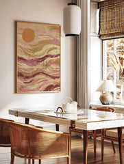 Abstract art print with an orange circle and flowing pink, magenta, and earthy brown waves, in a styled room mockup