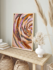 Abstract art print with swirling bands of brown, orange, pink, and purple dots on a light, in an alternate framed mockup