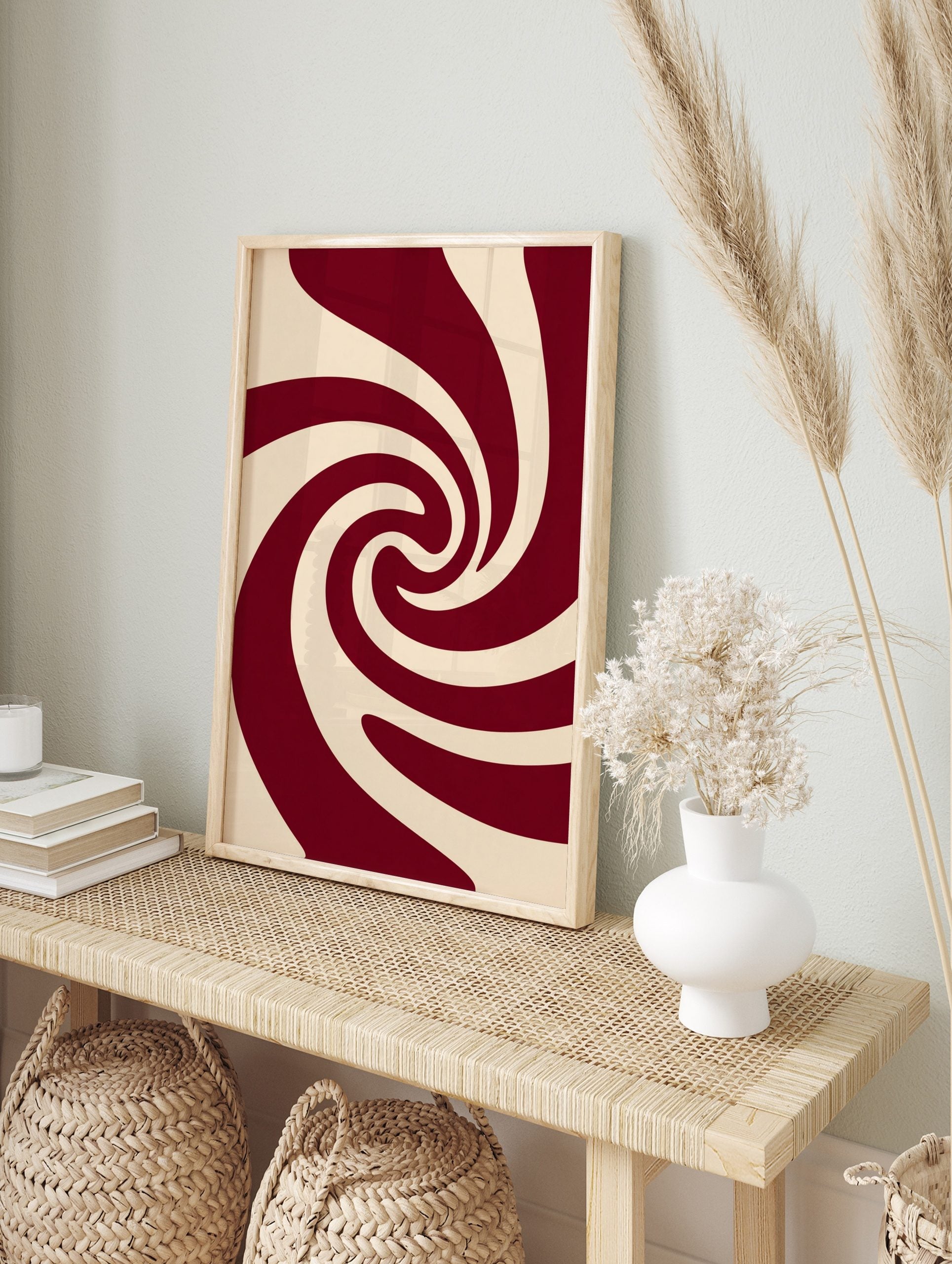 Abstract swirling pattern wall art in deep red and cream, with smooth, curved lines creating, in an alternate framed mockup