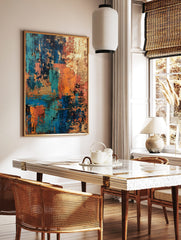 Abstract art print with distressed textures in teal, blue, orange, and gold, layered in a vertical, in a styled room mockup