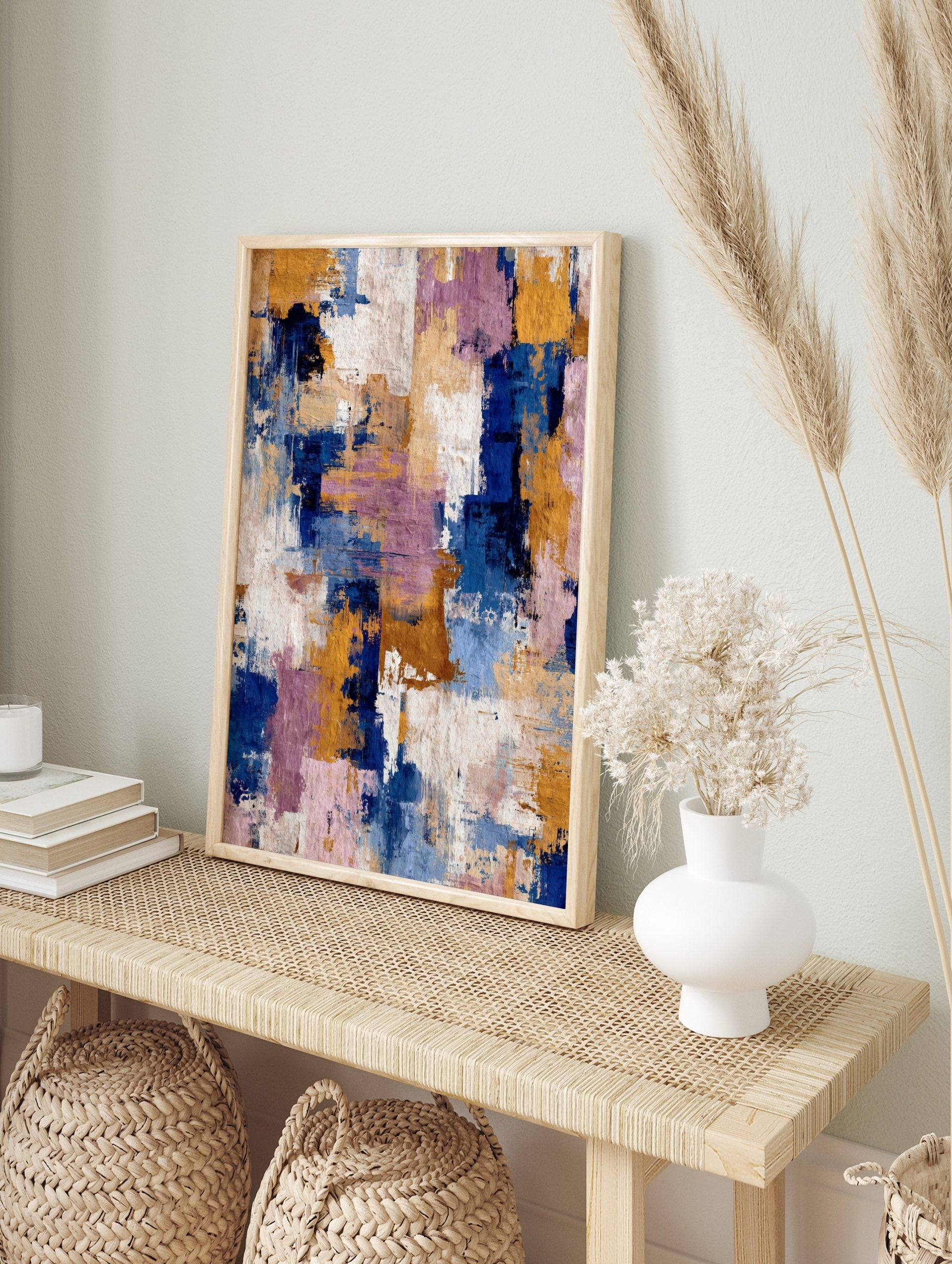 Abstract textured wall art with broad brushstrokes in navy blue, golden yellow, purple, and, in an alternate framed mockup