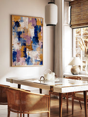 Abstract textured wall art with broad brushstrokes in navy blue, golden yellow, purple, and white, in a styled room mockup