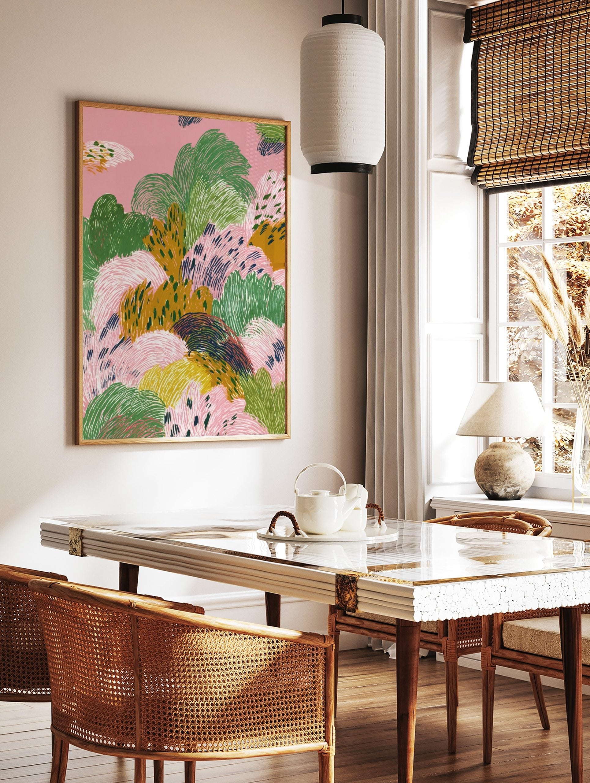 Abstract landscape art print with textured organic shapes in pink, green, and mustard yellow, in a styled room mockup