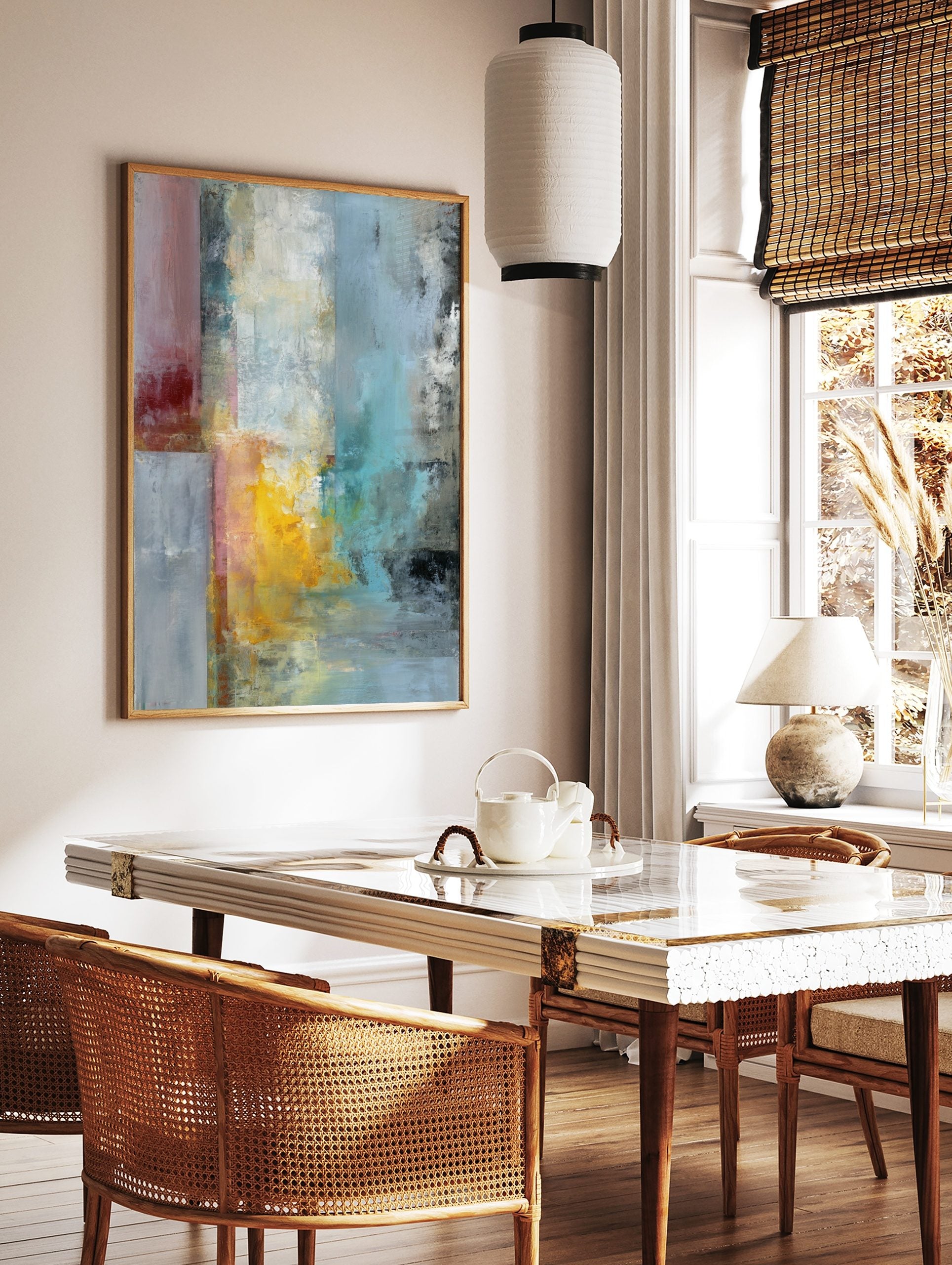 Abstract textured wall art with vertical blocks of red, yellow, blue, and grey paint on a canvas, in a styled room mockup