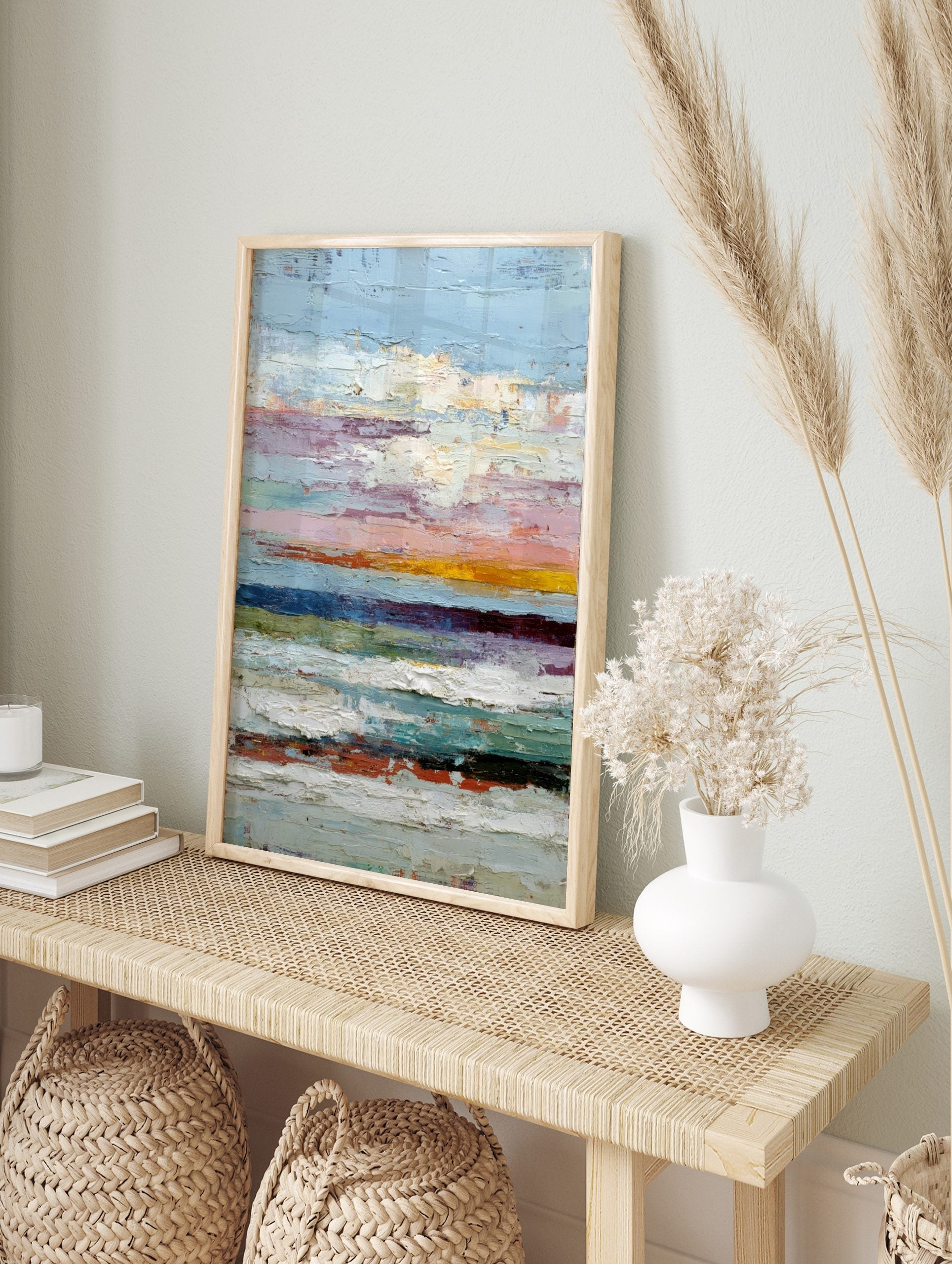 Abstract textured wall art with horizontal stripes of blue, pink, orange, green, and white, in an alternate framed mockup