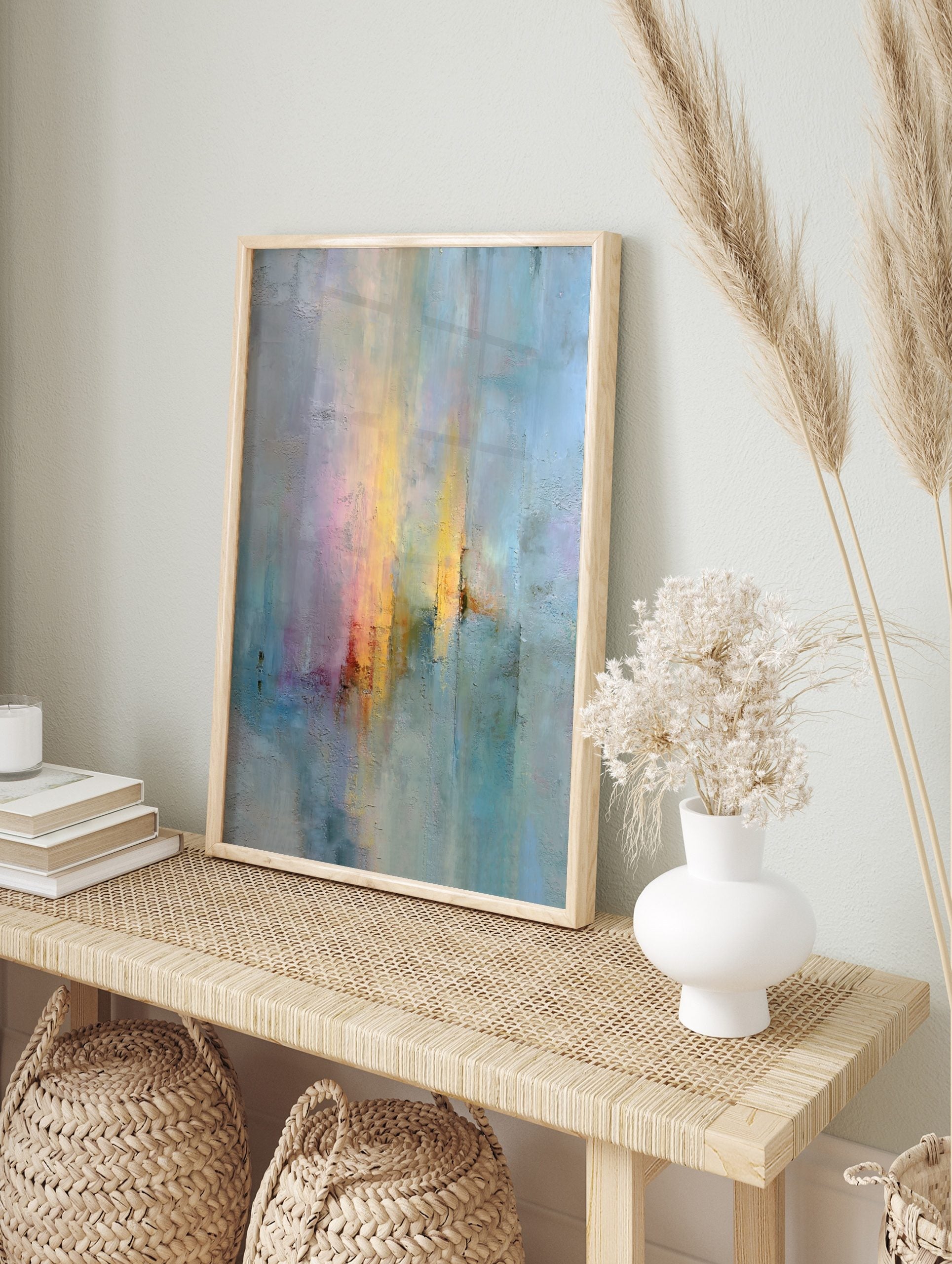 Abstract textured wall art with vertical yellow, orange, pink, blue, and grey streaks on paper, in an alternate framed mockup