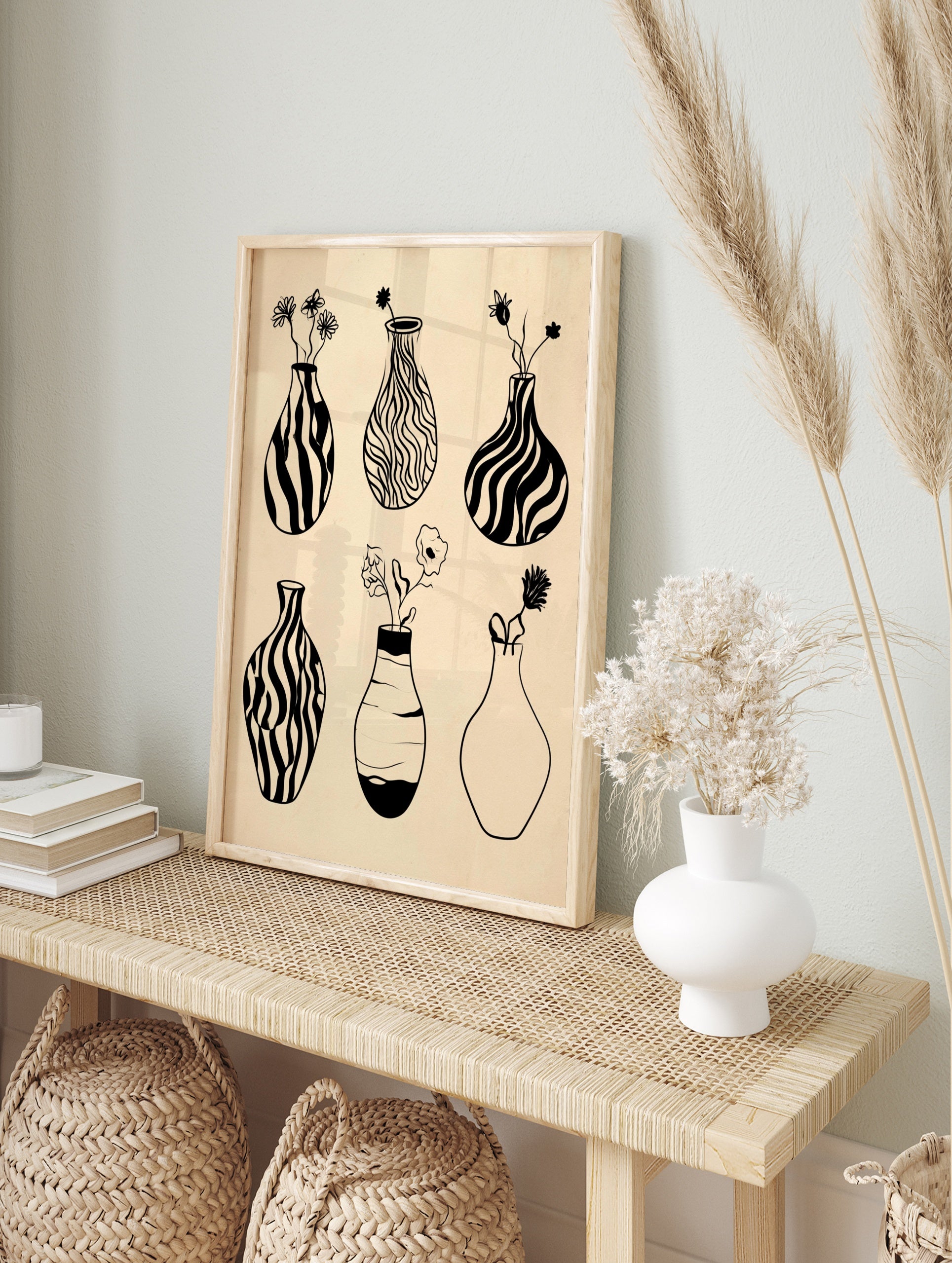 Minimalist black and white line art of six vases with flowers on a beige background, in an alternate framed mockup