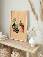 Abstract illustrative wall art print of five patterned vases with botanical flowers on a tan, in an alternate framed mockup