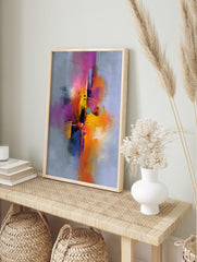 Abstract art print with vibrant pink, orange, yellow, purple, and black splashes on a, in an alternate framed mockup