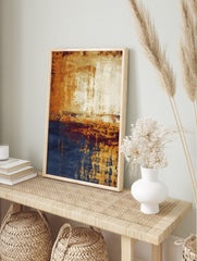 Abstract wall art with golden orange, deep blue, and cream distressed textures in a vertical, in an alternate framed mockup