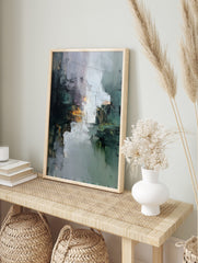 Abstract wall art with textured impasto strokes in grey, dark teal, black, and gold, in an alternate framed mockup