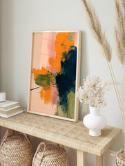 Abstract wall art with layered brushstrokes in orange, navy, olive green, and pink on a pale, in an alternate framed mockup