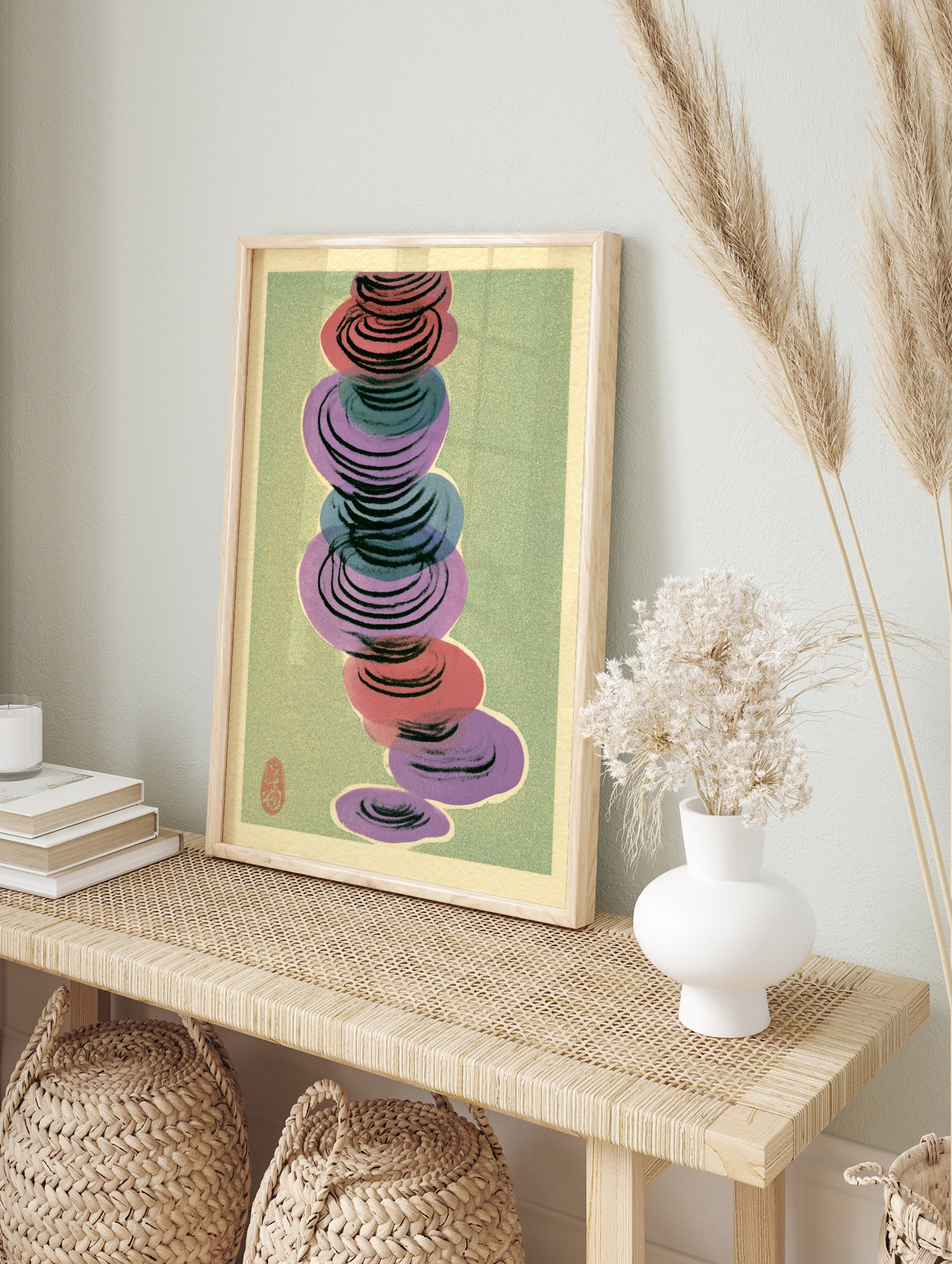 Abstract wall art with stacked red, purple, and blue circular shapes on a muted green, in an alternate framed mockup