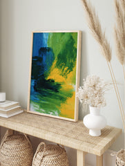 Abstract wall art print with bold blue, green, and yellow painterly brushstrokes and dynamic, in an alternate framed mockup