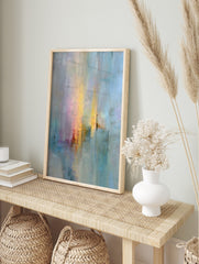 Abstract wall art print with vertical strokes of blue, yellow, pink, and red, textured, in an alternate framed mockup