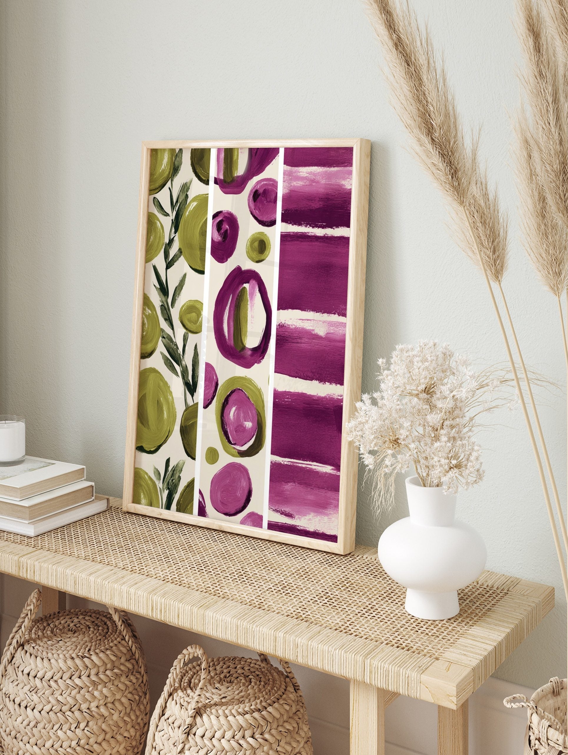 Abstract art print with green leaves, magenta and olive green brushstroke circles, and, in an alternate framed mockup