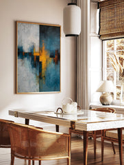Abstract wall art print with textured blue-teal, yellow, and white intersecting shapes and forms, in a styled room mockup