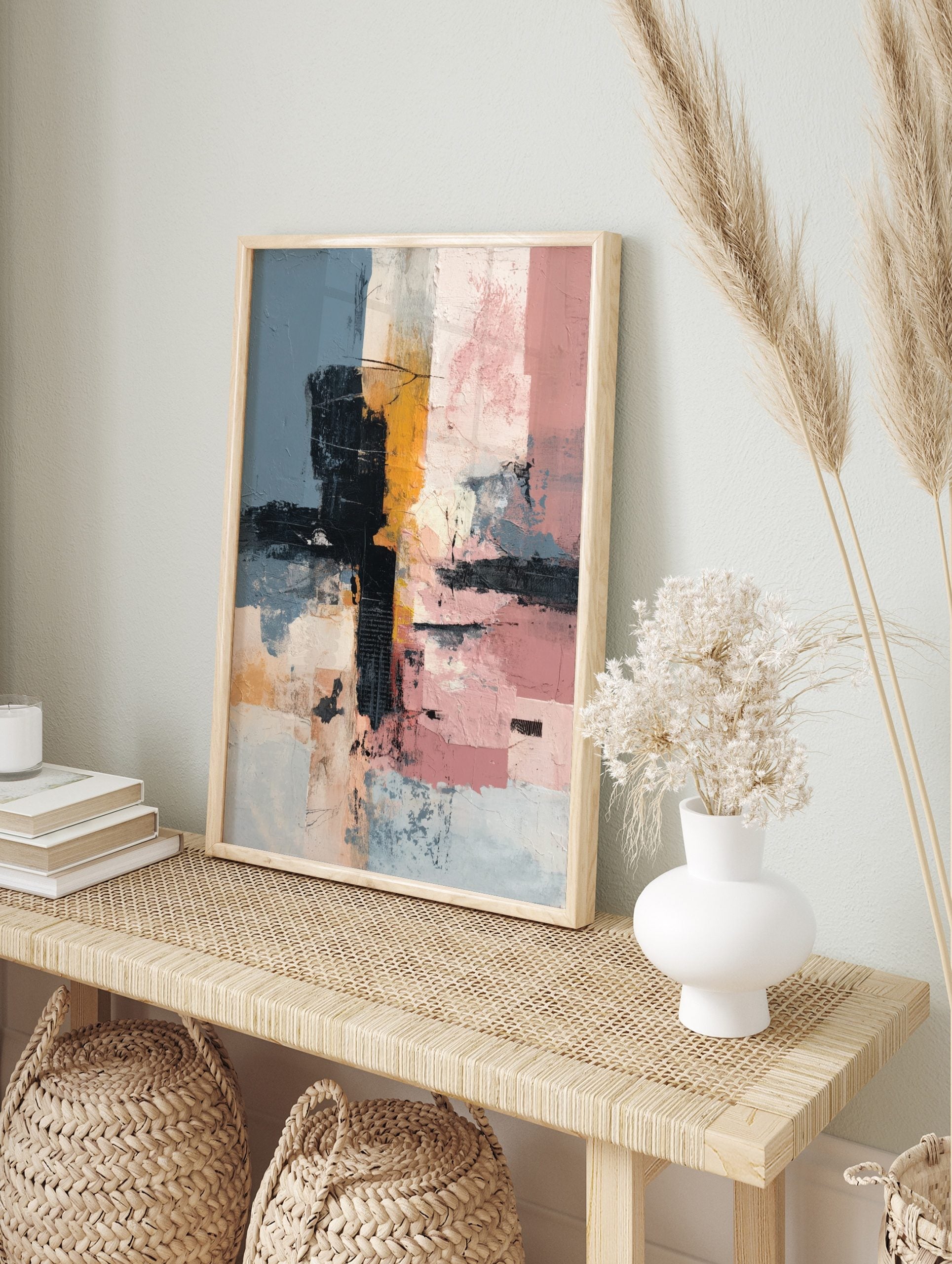Abstract wall art with textured blocks of muted blue, black, mustard yellow, and pink, in an alternate framed mockup