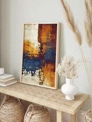Abstract wall art print with distressed textures in ochre, deep blue, reddish-brown, and, in an alternate framed mockup