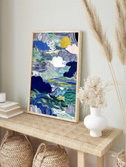 Abstract blue and green wavy landscape art print with stylised clouds and a golden sun, in an alternate framed mockup