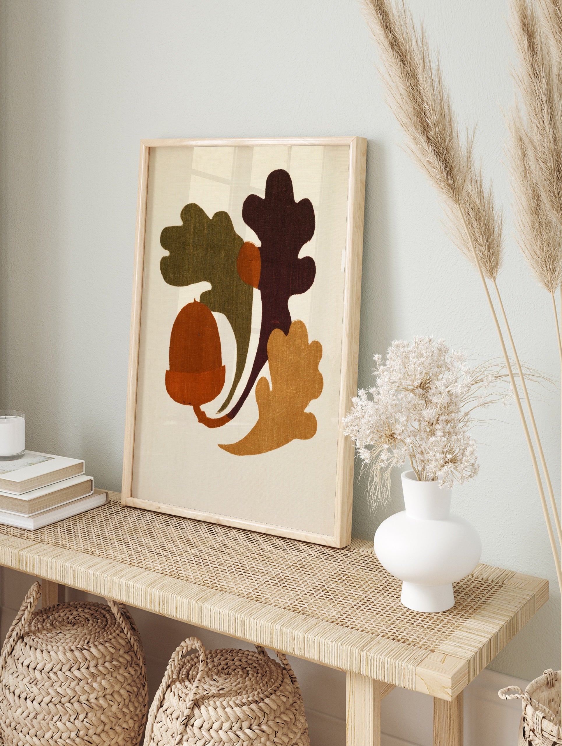 Minimalist illustrative art print featuring an acorn and oak leaves in earthy orange, green, in an alternate framed mockup