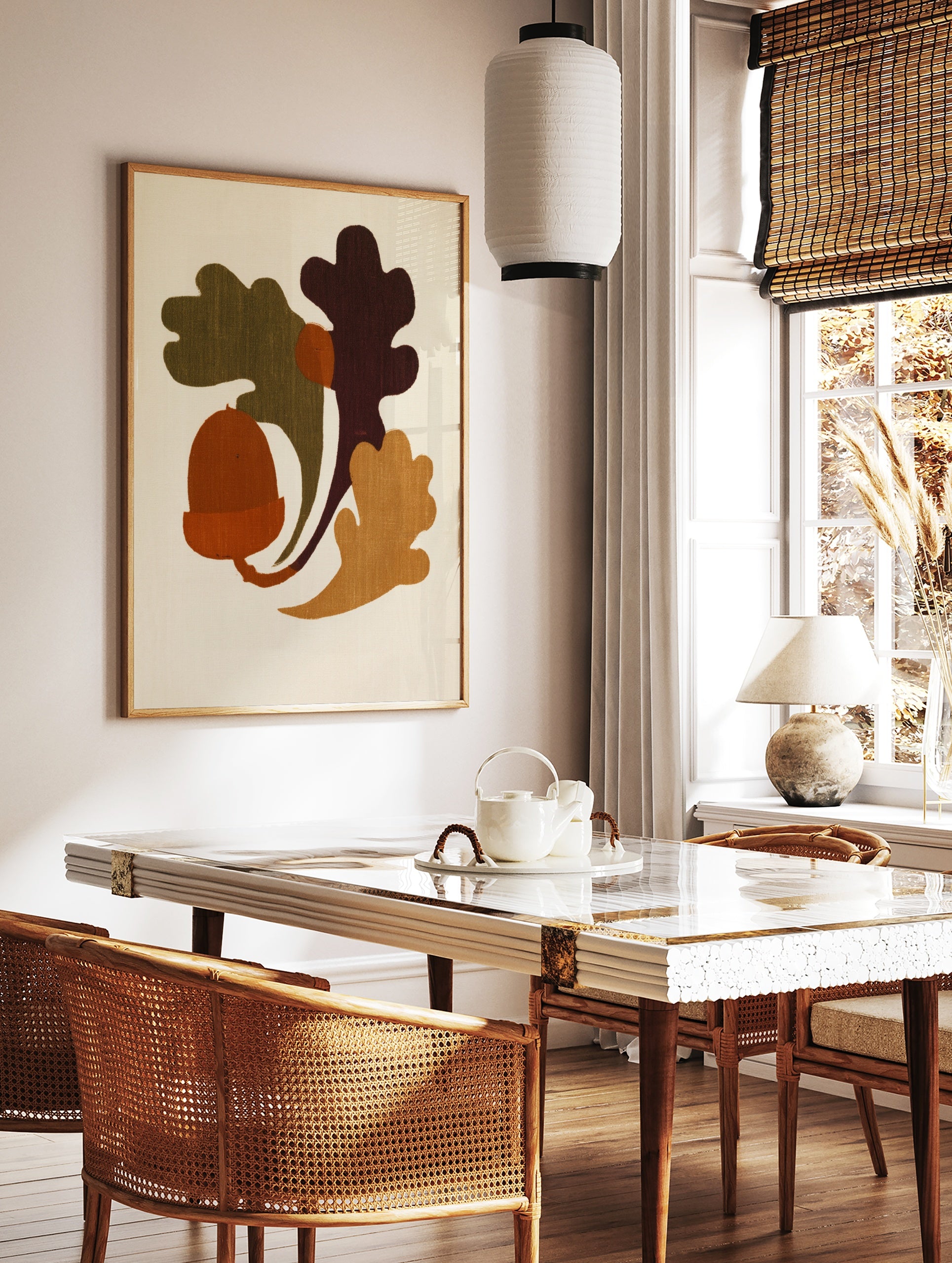 Minimalist illustrative art print featuring an acorn and oak leaves in earthy orange, green, and, in a styled room mockup