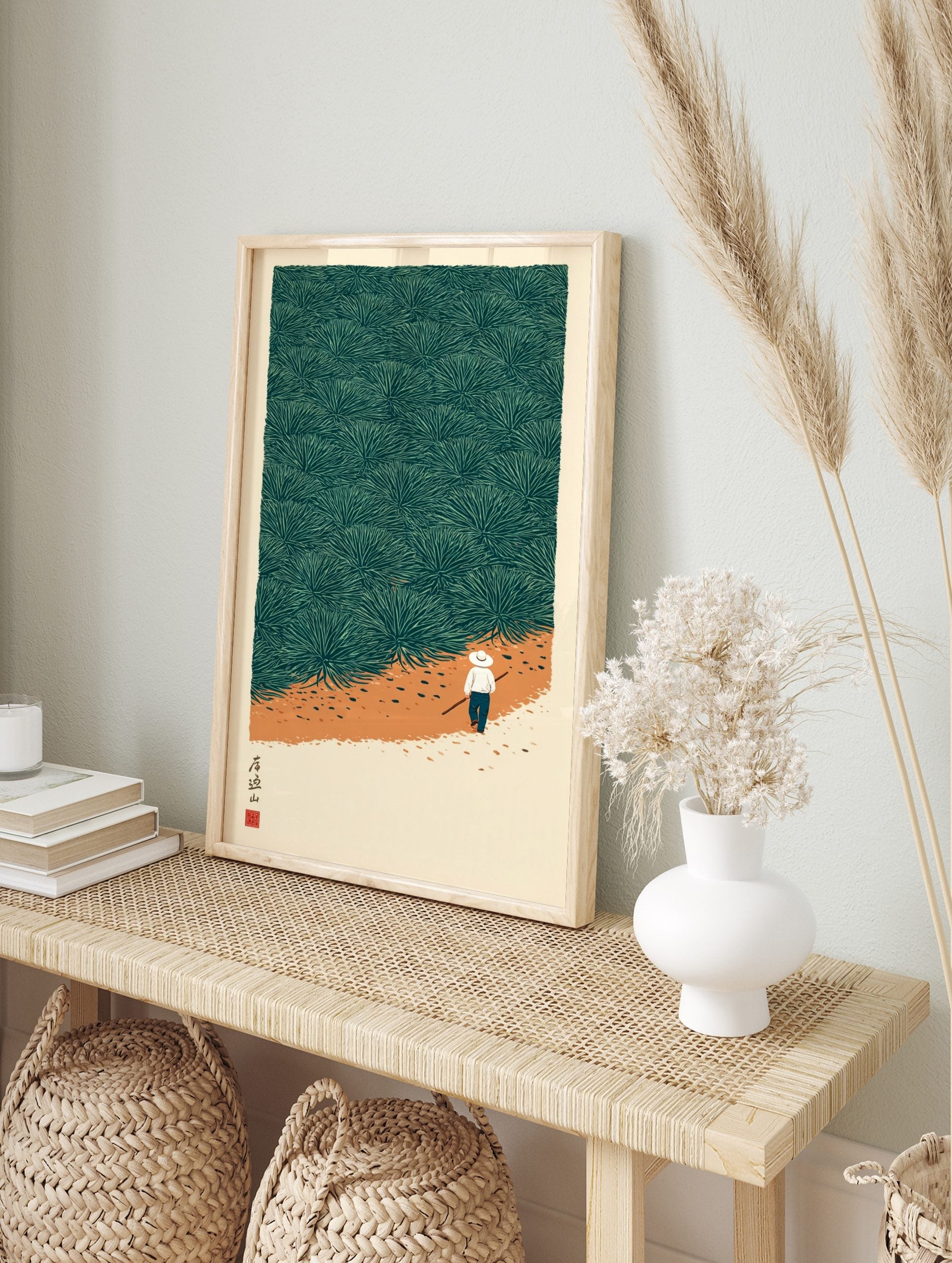 Illustrative print of a person walking a path through a dense field of green agave plants, in an alternate framed mockup