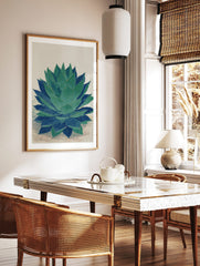 Agave plant botanical wall art print in green and blue with textured illustration style, in a styled room mockup