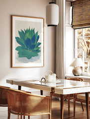 Botanical illustration print of an agave plant with large green and blue succulent leaves on a, in a styled room mockup