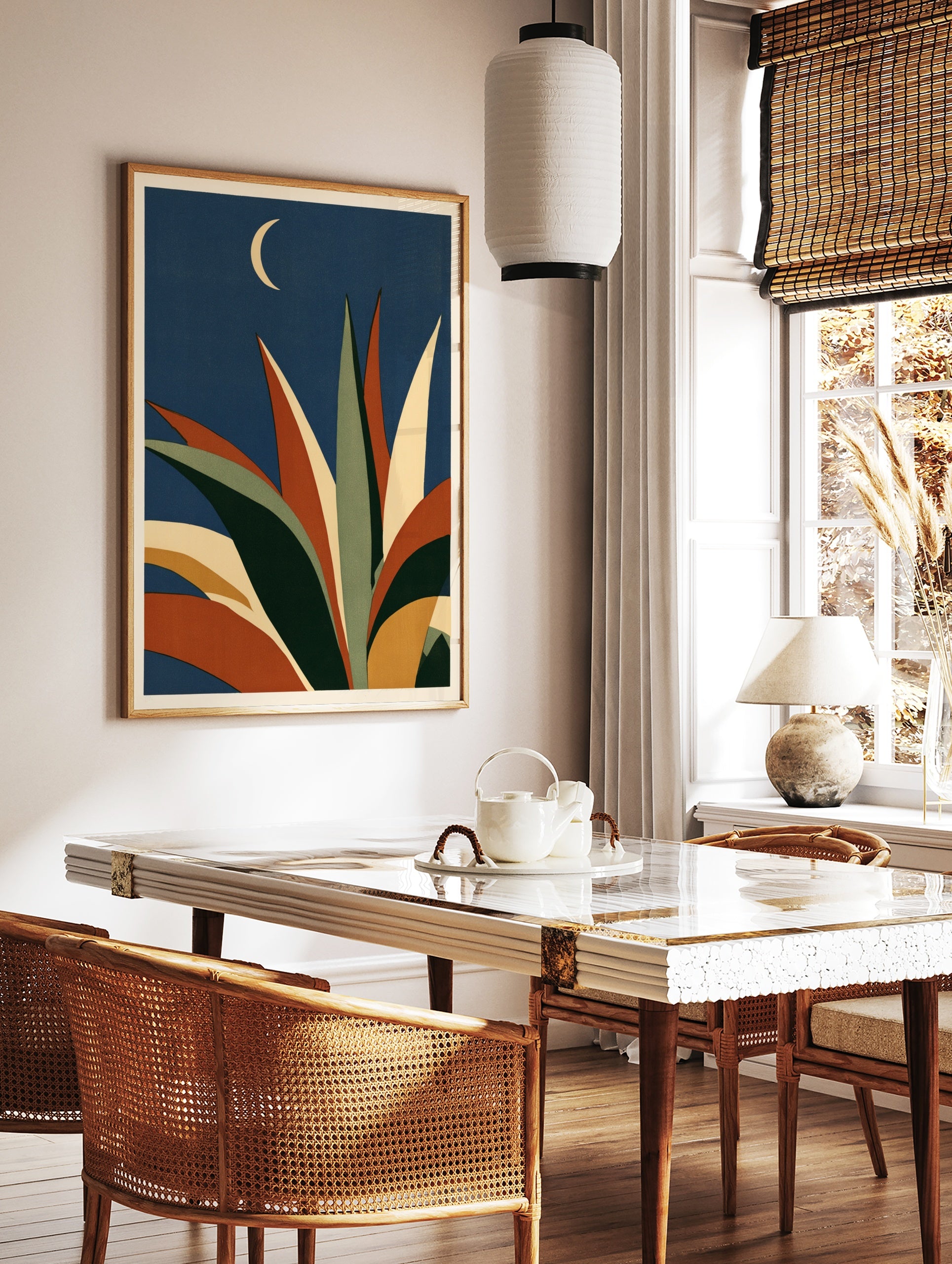 Abstract agave plant illustration with orange and green leaves against a dark blue sky with a, in a styled room mockup
